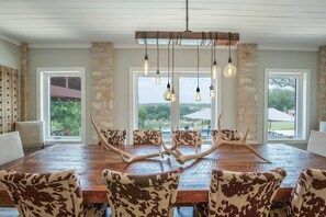Our dining area is unique and chic, with seating for 12 and big windows to watch the poolside view.