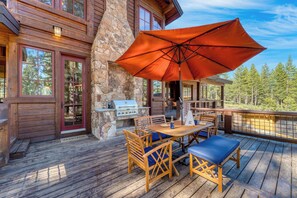 Perfect for outdoor feasts: our deck features a BBQ grill, chairs, tables, and a shady umbrella.