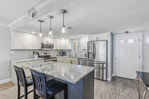 Stainless steel appliances and granite counters in this spacious, fully equipped kitchen