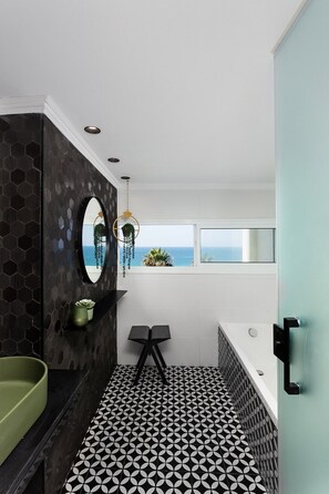 Elegant bathroom with a rain shower head and a window for great ventilation (please note the bathtub cannot be sealed to fill with water).