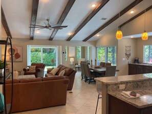 Open concept living, dining, kitchen, bar area.