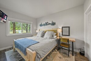Master bedroom with king bed, work desk/makeup station and TV