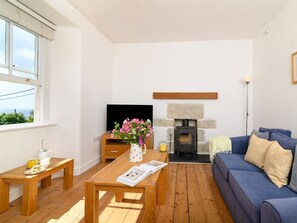 Bright sunny sitting room with sea views & wood burner