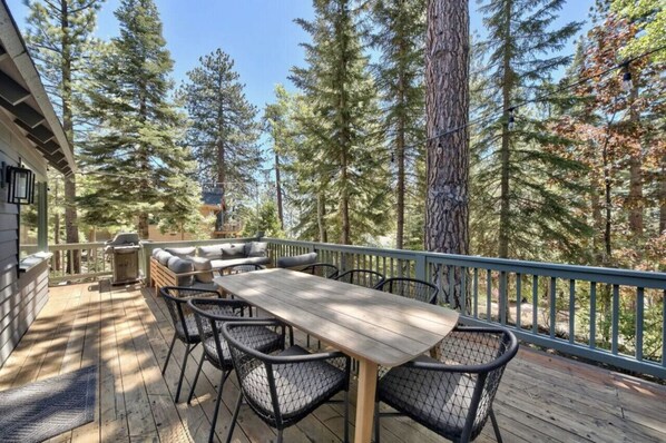 Another view of the outdoor deck that feels so private among the towering pines.