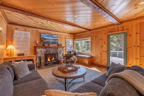 Cozy living room with plenty of seating, natural light and beautiful decor.