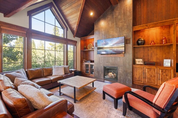 Beautiful living space with plenty of natural light, fireplace and comfortable seating for all.