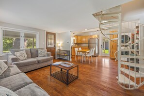 Living room is open to the kitchen in this cozy cottage