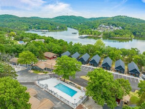 This peaceful lakeside aerial view is a serene and welcoming scene, nestled in nature’s embrace