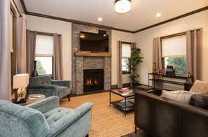 Inviting living room with plush seating, a cozy fireplace, and elegant decor, creating a warm and welcoming atmosphere.