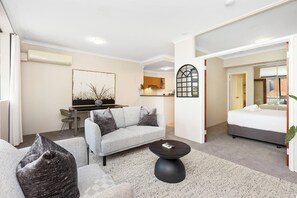 Experience luxury urban living with sleek interiors in our open-plan apartment, complete with a fully equipped kitchen and cozy dining area.