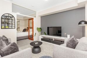 Our living room is perfect for both relaxation and work, equipped with comfortable seating, a large TV, and high-speed internet for all your needs.