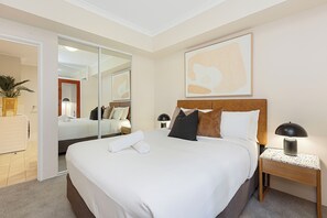 Step into our executive bedroom, designed with modern elegance. It features a luxurious queen-sized bed, high-end furnishings, and a soothing colour palette that ensures restful sleep and a rejuvenating start to your day.