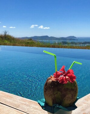 Enjoy a refreshing coconut whilst looking out beyond the infinity pool