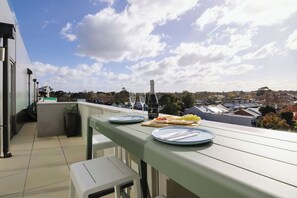 Unwind with a book or enjoy a morning coffee on your balcony oasis, complete with a cosy chair and table