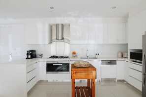 Whip up culinary masterpieces in our modern kitchen, where every detail is designed for your convenience and culinary creativity