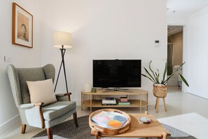 Our cosy living area invites you to relax and enjoy your favorite shows on the sleek TV.