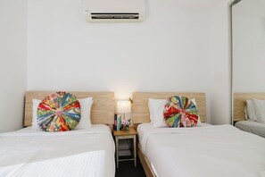 2 Single Beds with balcony access and large wardrobe.
