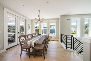 Dining table with chairs for eight and bench for additional seating.