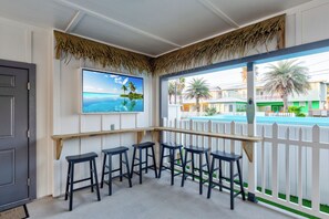 Outdoor TV and bar area in the carport