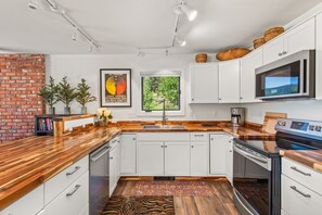 Fully-equipped kitchen with new appliances and ample cooking space.
