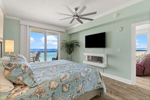 The gulf front master bedroom offers a King size bed, television, ensuite bathroom, electric fireplace, and incredible views!