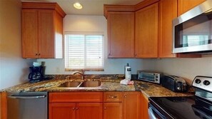 Kitchen - Stainless steel appliances and granite countertops.