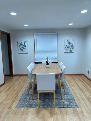 Dinette is open to kitchen with hardwood flooring and recessed lighting. 