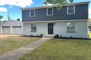 Front of home is well lit w/detached garage & parking for 4 cars in the driveway