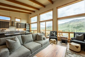 Cozy living area offering natural light, fireplace and mountain/ lake views!