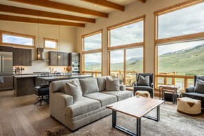 Cozy living area offering natural light, fireplace and mountain/ lake views!