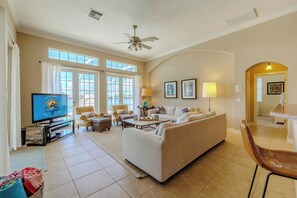 Bright Retreat - - Natural light streaming through large windows into this living area
- Comfortable seating arrangements and elegant decor create the perfect ambiance for relaxation
- Enjoy seamless access to outdoor spaces, ideal for entertaining or peaceful retreats