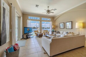 Sunlit Haven - - Immerse yourself in comfort as sunlight pours into this cozy living room
- Plush seating and tasteful accents invite you to unwind with a stunning view beyond the glass doors
- Step outside to embrace seamless indoor & outdoor living at its finest