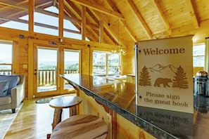 Bear View Cabin’s cozy living area with sign in book