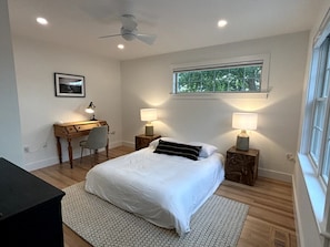 Downstairs master suite with a queen bed and attached full bathroom (frame has been delivered, just not shown in photo)