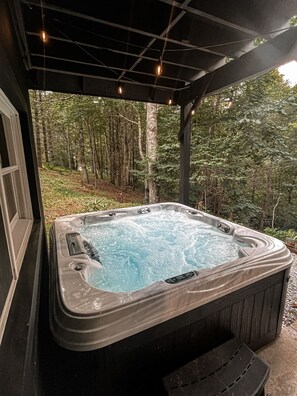 Covered Hot tub area nestled in the trees