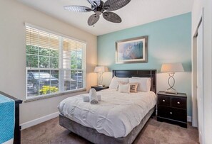 Cozy master bedroom with plush bedding and natural light for a restful sleep.