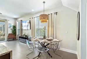 Bright dining area with seating for six, perfect for family meals.