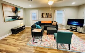 A view from the kitchen area. The 50” Amazon Fire HD TV in the living room streams all your favorite apps for your entertainment.