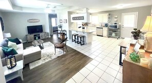 View from the front door when you walk in.  Open concept living area includes a full kitchen, counter bar with two seats, dining area for four, wine cabinet, and living room.