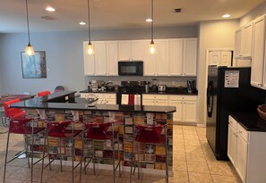 Open plan (fully loaded) kitchen with breakfast bar