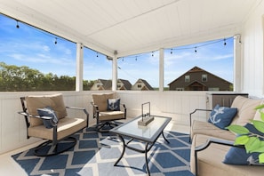 The private screened in porch is the perfect spot to gather and unwind.
