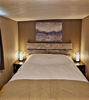 Bedroom with queen bed, bedstands, lighting and charging ports. Closet w/hangers