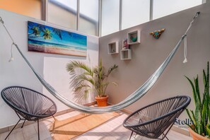 The sunroom has a hammock, Acapulco chairs and Zen vibes