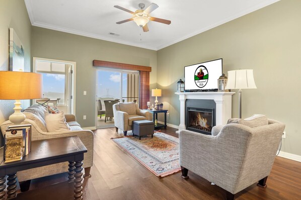 Living Room with Seasonal Fireplace, Cable TV, Patio & Sunroom Access, and a Sleeper Sofa