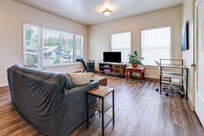 Living Room | Free WiFi | Flat-Screen TV | Window A/C Unit | Workspace Area