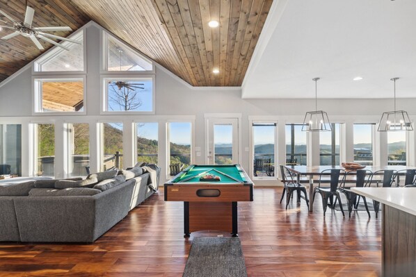Elevate your entertainment space with our stylish pool table, perfectly placed in the heart of our living room and kitchen area