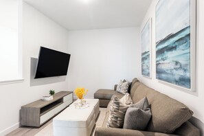 Perfect for movie nights: enjoy our cozy couch and TV setup.