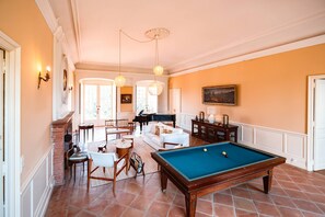 Lounge with : French billiards - Sofa + armchairs - XGIMI Halo+ overhead projector - Piano - Fireplace - Large light-filled room.