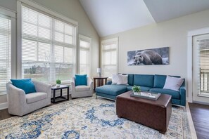 Lounge in the Living Room with floor to ceiling windows overlooking Monterra Golf Course