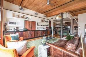 Lounge area with ample seating and lighting. Apple TV and a boom box for music 